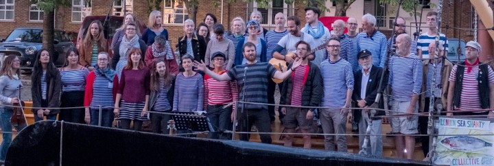 The London Sea Shanty Collective sing on the Thames barge Melissa at Greenland Dock